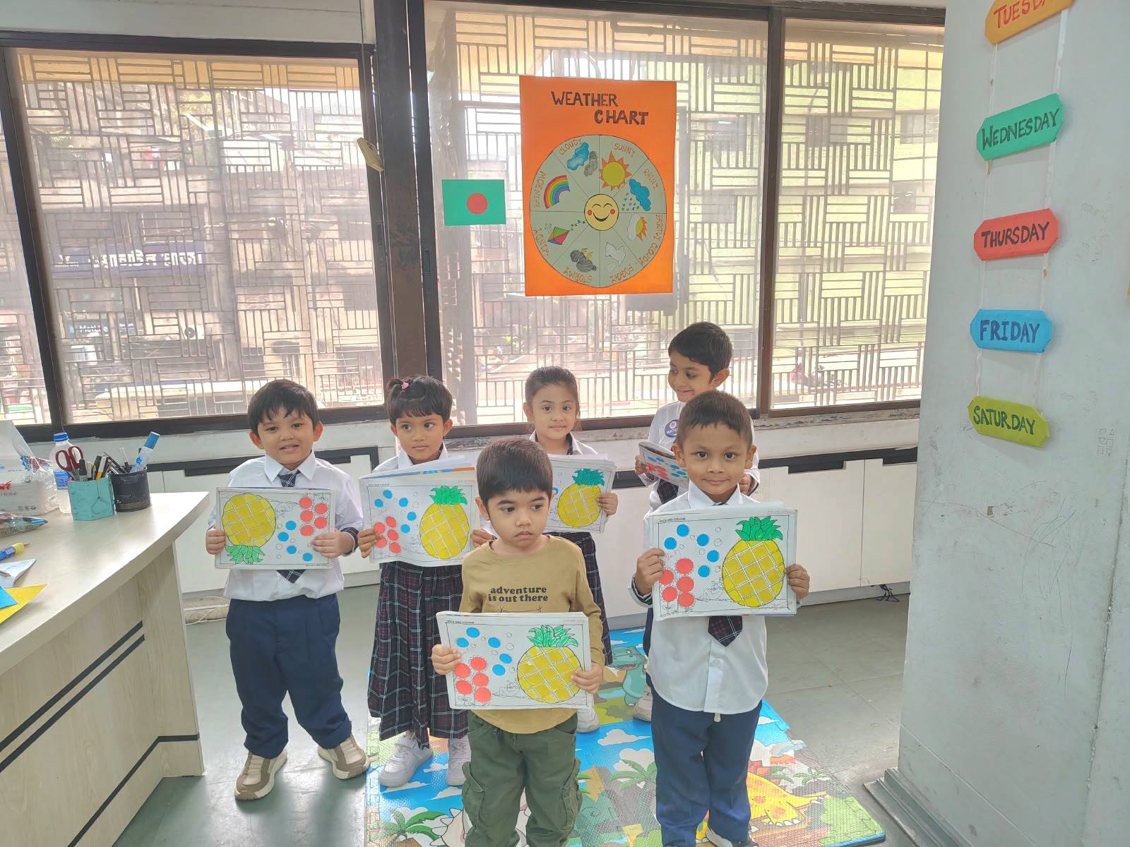 Students holding up colourful artwork